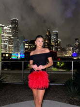 Red ostrich feather handbag, being held, front side
