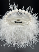 White ostrich feather handbag interior showing magnetic closure and jade bead handle 