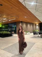 Brown feather handbag with gold chain handle styled with a brown evening dress