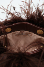 Interior of brown feather handbag with magnetic closure and satin lining