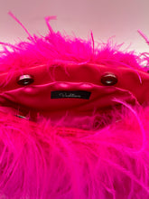 Close-up of hot pink ostrich feather handbag interior featuring pink satin lining, magnetic closure, and Vashtieve label.