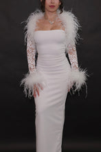 Back view of a white sheer floral lace bolero with ostrich feather trim across the shoulders and dramatic feather cuffs.