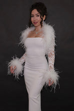White lace bolero with luxurious ostrich feather trim along the neckline and cuffs, styled over a white strapless maxi dress.