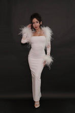 Model wearing a white floral lace bolero with ostrich feather shoulder and wrist trim, paired with an elegant white fitted maxi dress.